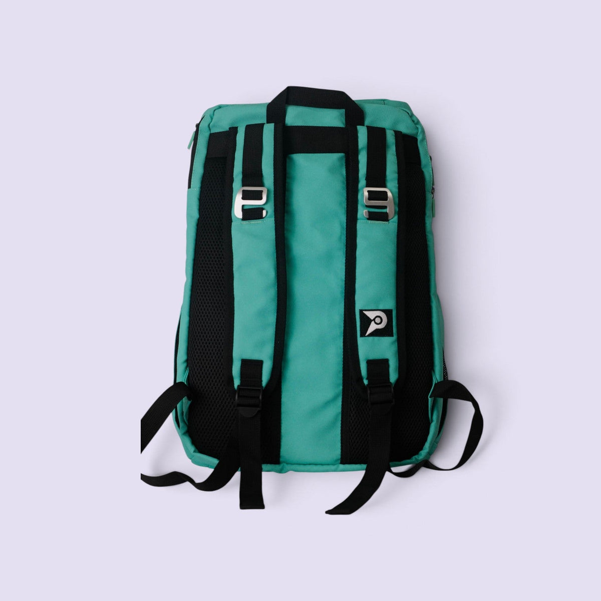 Back view of the teal PVT Pickleball ARC bag featuring black mesh cushioning, adjustable straps, and fence hooks.